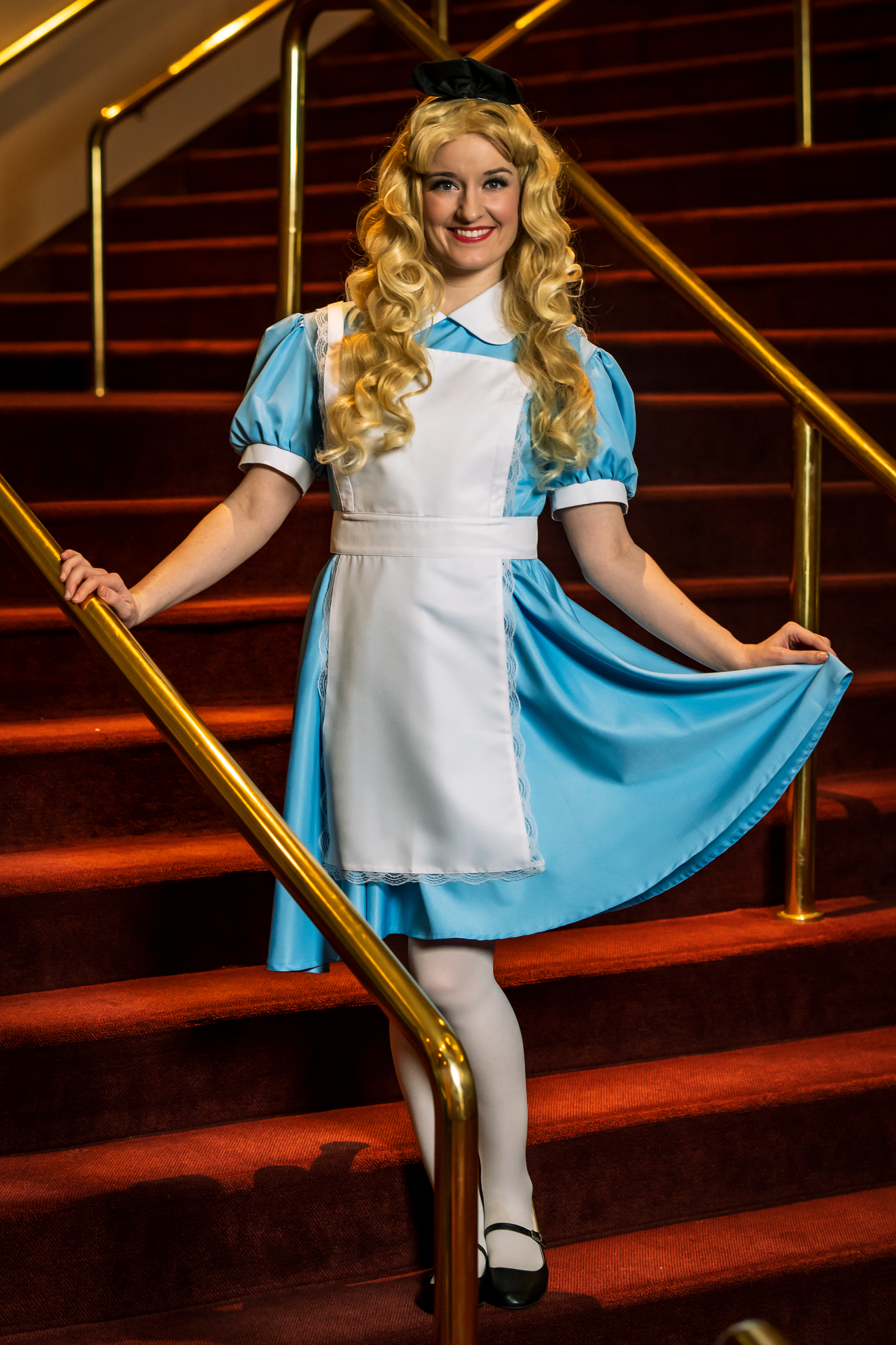 Alice character in blue dress at a children's party