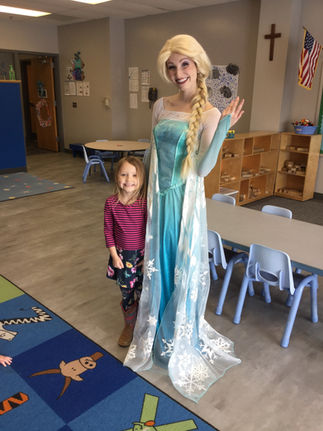 Snow Queen with a child during a classroom visit