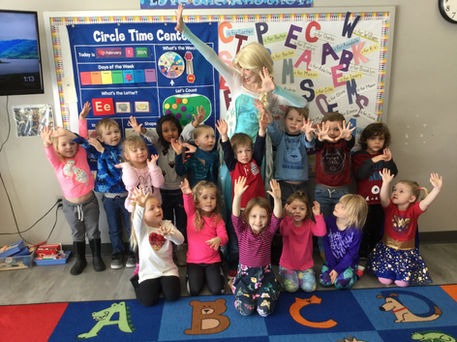 Snow Queen posing with a full class of children during a school visit